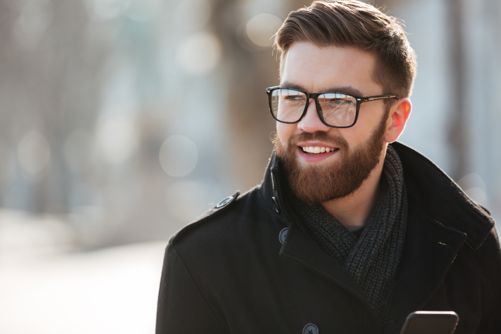 portrait-happy-bearded-young-man-glasses-standing-outdoors